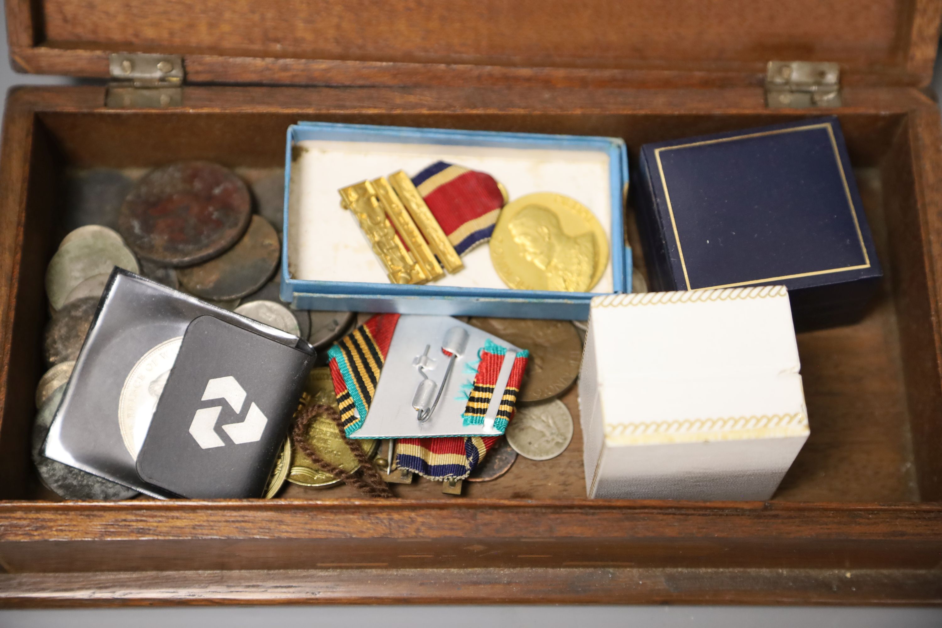 Mixed coinage, medals, photos and posters in a wooden box